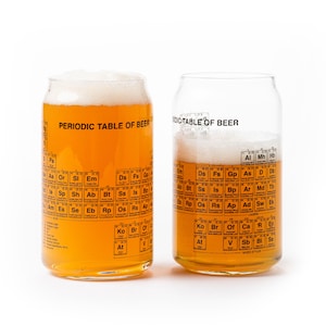 May include: Two clear glass beer mugs with a periodic table of beer printed on them. The mugs are filled with a light amber colored beer and have a white foam head.