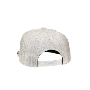May include: A gray heather baseball cap with a black brim and a white adjustable strap in the back.