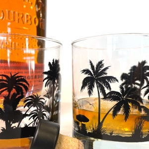 Ocean and palm tree design wrapping around whiskey glass