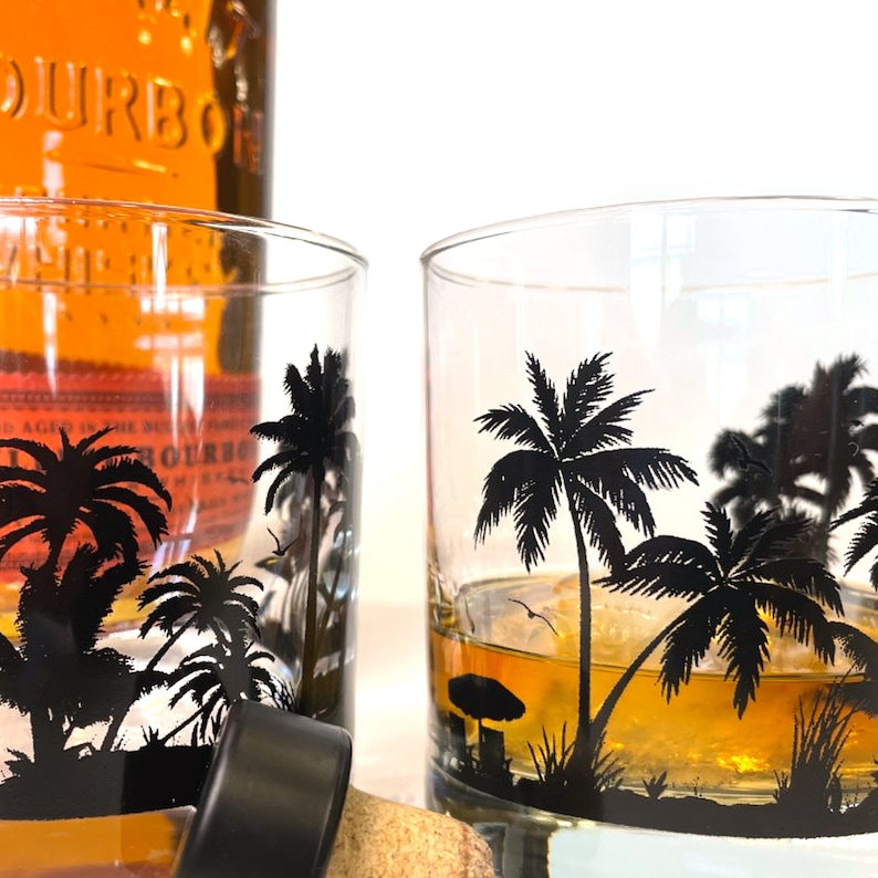 Ocean and palm tree design wrapping around whiskey glass