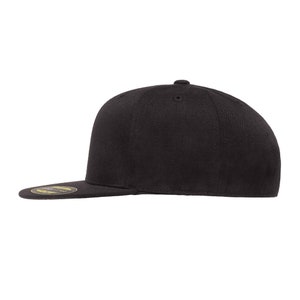 May include: A black flat brimmed baseball cap with a curved brim.