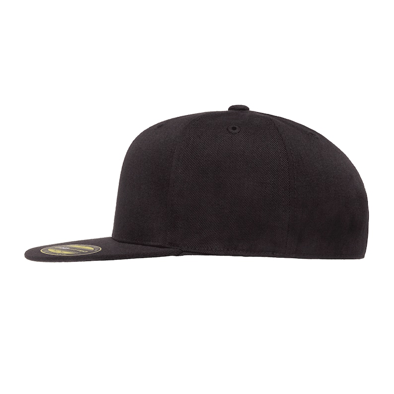 May include: A black flat brimmed baseball cap with a curved brim.