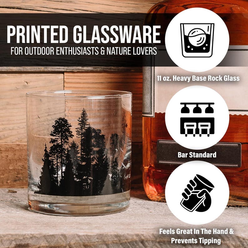 Close-up of black ink mountain print on whiskey glass