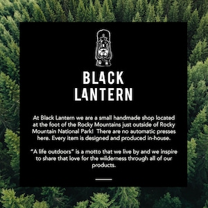 Logo image for Black Lantern Studio inset inside over an outline of tall pine trees viewed from above. The logo square contains white lettering on a black background. The words explain this is a small Colorado shop with the motto A life Outdoors.
