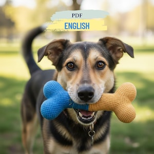 May include: A dog with brown and black fur holds a blue and yellow crochet bone toy. The dog is looking at the camera. The image has the text "PDF ENGLISH" in the upper portion. The background is blurred.