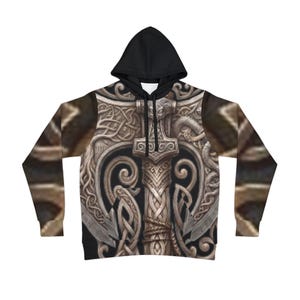 May include: A black hooded sweatshirt with a detailed, ornate design of a hammer, possibly Mjolnir, with intricate knotwork and a weathered appearance. The sleeves have a brown, textured pattern. The hood is solid black.