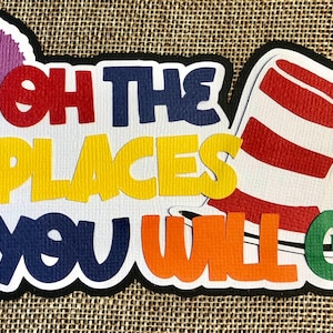 May include: A colorful paper cutout featuring the phrase "Oh the Places You Will Go" in various colors. The design includes a purple tree, a red and white striped hat, and a black border. The background is a textured tan surface.
