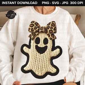 May include: White sweatshirt featuring a smiling ghost design with a leopard print bow. The ghost has a textured, knitted appearance and a black outline. The words "INSTANT DOWNLOAD" and "HIGH QUALITY" are visible.