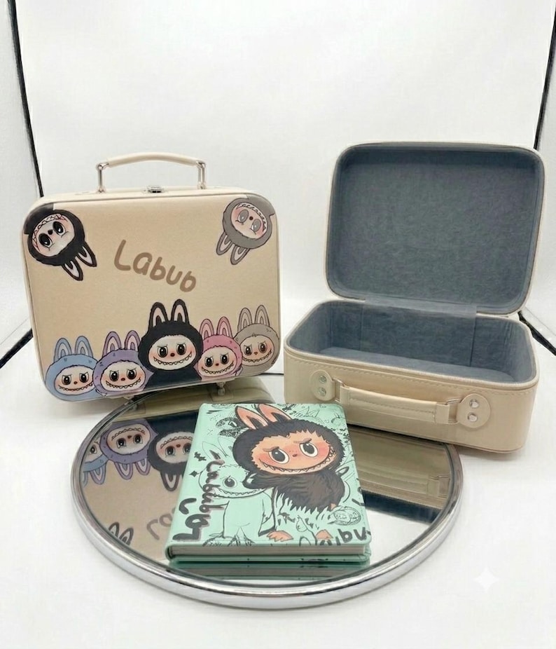 May include: Two beige rectangular storage cases with top handles and a light green notebook. The cases feature cartoon character illustrations and the text Labub. One case is closed, and the other is open, revealing a grey interior lining.