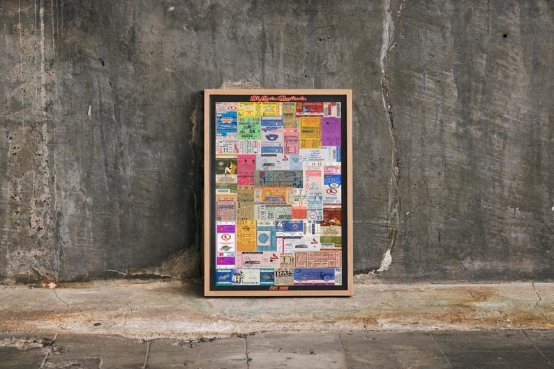 May include: A rectangular framed wall art piece featuring a collage of various colorful vintage ticket stubs in shades of blue, red, yellow, and green. The top of the frame displays the text "El Arte de Coleccionar" and the bottom displays "EST. 2020".