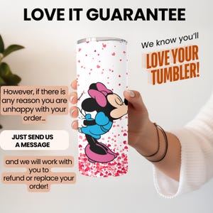 May include: A white tumbler decorated with a Minnie Mouse design in pink and blue, with pink hearts. The tumbler has the text "LOVE YOUR TUMBLER!" and "LOVE IT GUARANTEE".