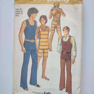 May include: Vintage Simplicity sewing pattern envelope featuring illustrations of four figures in 1970s knit clothing. The envelope is cream-colored with text and the number 9385. The figures are wearing a blue tank top and pants, striped shorts, and a vest with patterned pants.