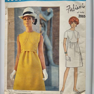 May include: Vintage Vogue Couturier Design pattern featuring a Fabiani of Italy design, number 2065. The cover showcases a woman in a yellow dress, white gloves, and a hat. Another illustration shows a woman in a white dress.