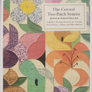 May include: A book cover titled "The Curved Two-Patch System" by Joyce M. Schlotzhauer. The cover features a colorful quilt design with floral patterns in shades of yellow, pink, purple, and green. The quilt design includes curved shapes and leaf patterns.