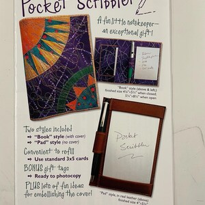 May include: A Pocket Scribbler sewing pattern instruction sheet featuring a purple fabric cover with a sun design, a book-style holder with a pen and 3x5 cards, and a leather pad-style holder. The text includes dimensions of 4.25 inches by 5.75 inches.