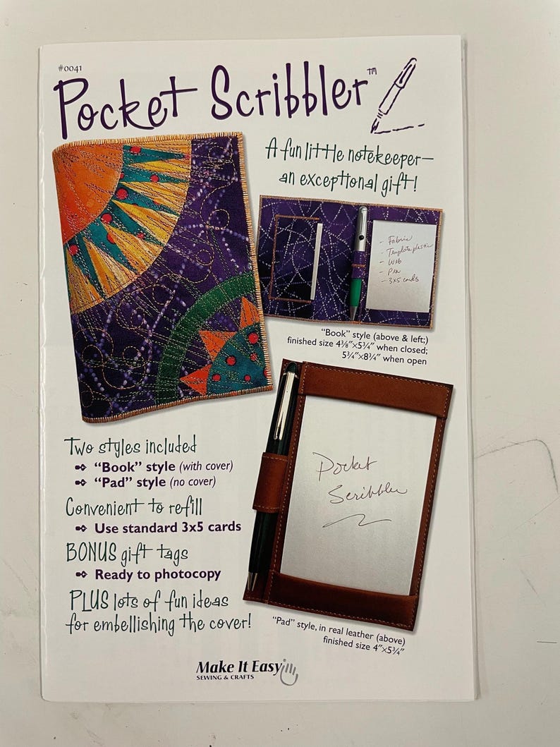 May include: A Pocket Scribbler sewing pattern instruction sheet featuring a purple fabric cover with a sun design, a book-style holder with a pen and 3x5 cards, and a leather pad-style holder. The text includes dimensions of 4.25 inches by 5.75 inches.