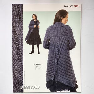 May include: A knitting pattern booklet titled Peruvia #264 featuring the Portia design. The cover displays a long, grey, ribbed knit coat with a central cable knit detail on the back, shown on a model, alongside a smaller front-view image.