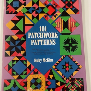 May include: A book cover for "101 Patchwork Patterns" by Ruby McKim. The cover has a purple background with colourful geometric quilt block designs. The designs are in various shapes and colours, including red, green, yellow, and black. The title is in white text.