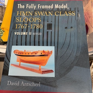 May include: A book titled The Fully Framed Model, HMN SWAN CLASS SLOOPS 1767-1780 VOLUME II REVISED by David Antscherl. The cover features a dark blue background with a technical illustration of a ship frame and a photograph of a wooden ship model.