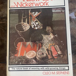 May include: A hardcover book titled Willow Spokes and Wickerwork by Cleo M. Stephens. The cover features a photograph of various woven baskets, mats, and footwear made from natural fibers, with the subtitle The nature book of weaving with wild-growing things.