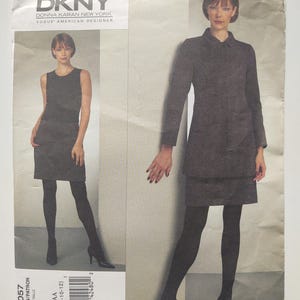 May include: A DKNY Vogue American Designer sewing pattern, V1057, featuring a woman in a gray dress and coat ensemble. The pattern includes sizes AA (6-8-10-12). The image shows the DKNY logo.