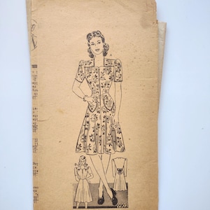 May include: Vintage sewing pattern featuring a floral print dress design. The illustration shows a woman in a short-sleeved dress with pockets, along with smaller diagrams. The pattern is printed on aged paper, with the number 9902 visible.