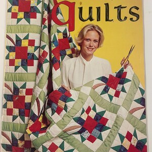 May include: A woman holds a quilt with a star pattern, featured on the cover of a book titled "Stitch'n Patch Quilts." The quilt has red, green, blue, and yellow squares. The background is yellow.