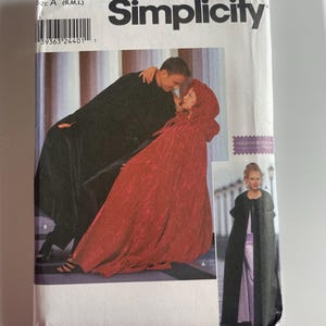 May include: A Simplicity 9452 sewing pattern envelope for capes in sizes S, M, and L. The front features a photograph of a person in a long black cape and another in a long red hooded cape, plus an inset photo of a person in a long black cape.