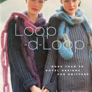 May include: A book cover for "Loop-d-Loop" shows two women in knitted sweaters and scarves. The cover text reads "MORE THAN 40 NOVEL DESIGNS FOR KNITTERS" and the author's name, Teva Durham. The image is a promotional shot for knitting patterns.
