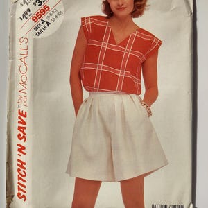May include: Vintage McCall's sewing pattern featuring a woman wearing a red plaid top and white shorts. The pattern is for size A (6-8-10). The text "STITCH 'N SAVE" is visible on the left side of the pattern.