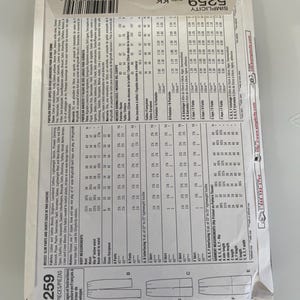 May include: A white Simplicity sewing pattern envelope for misses' slim pants and skirts, model 5259, size KK. The back of the envelope displays detailed fabric requirements, body measurements in centimetres, and technical line drawings of the garments.