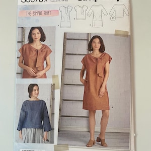 May include: Simplicity sewing pattern S8878 for The Simple Shift dress and top. The envelope features illustrations and photographs of garments with a tie-neck detail, short sleeves, and pockets. Sizes range from XS to XL. Includes technical line drawings.