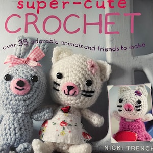May include: A book cover with the title "super-cute CROCHET" in pink letters. The cover features two crocheted animals: a gray bunny with a pink bow and a white cat wearing a floral dress. The book promises over 35 adorable animals to make.