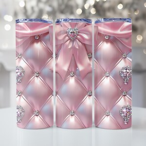 May include: Three pink tumblers with a quilted pattern, adorned with a bow and heart-shaped jewel. Each tumbler features diamond-like embellishments. The design is a glamorous, feminine style, perfect for beverages.