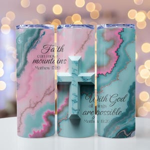 May include: Three stainless steel tumblers with a marble design in teal, pink, and gold. One tumbler features a cross, while the others have inspirational quotes: "Faith can move mountains" and "With God all things are possible."