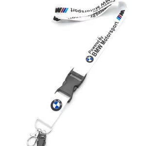 May include: White lanyard with the BMW Motorsport logo and text. The lanyard features a black plastic buckle and a metal clip. The BMW logo is a blue, white, and black circle. The text reads "Powered By BMW Motorsport".