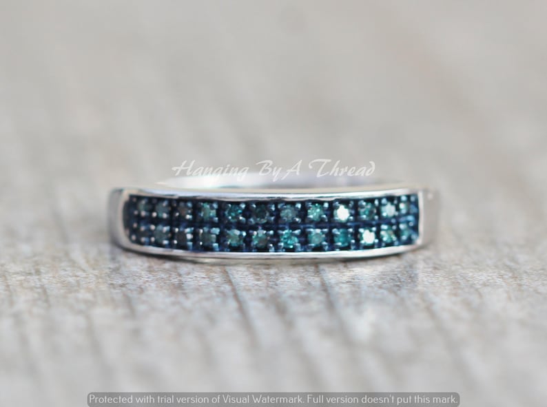 May include: A silver band ring with a double row of blue diamonds.