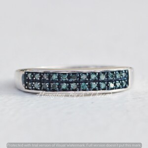 May include: A silver band ring with two rows of small, dark blue diamonds.