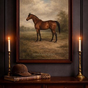 May include: A framed painting of a brown horse in a field, set against a cloudy sky. The artwork hangs above a dark wooden table with a riding helmet, book, and candle holders. Two lit candles flank the painting, creating a warm ambiance.