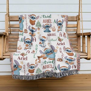 A cozy blanket featuring the character Ariel from the Disney movie Lilo and Stitch, with the character's name repeated in various colors and designs throughout the blanket.