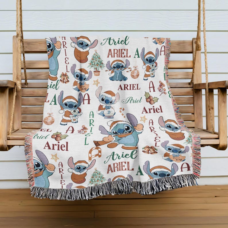 A cozy blanket featuring the character Ariel from the Disney movie Lilo and Stitch, with the character's name repeated in various colors and designs throughout the blanket.
