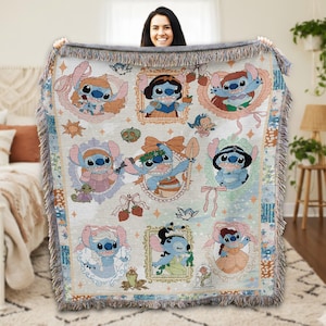 A woman is holding up a colorful, embroidered blanket featuring various characters from the Disney movie "Strawberry Fields".