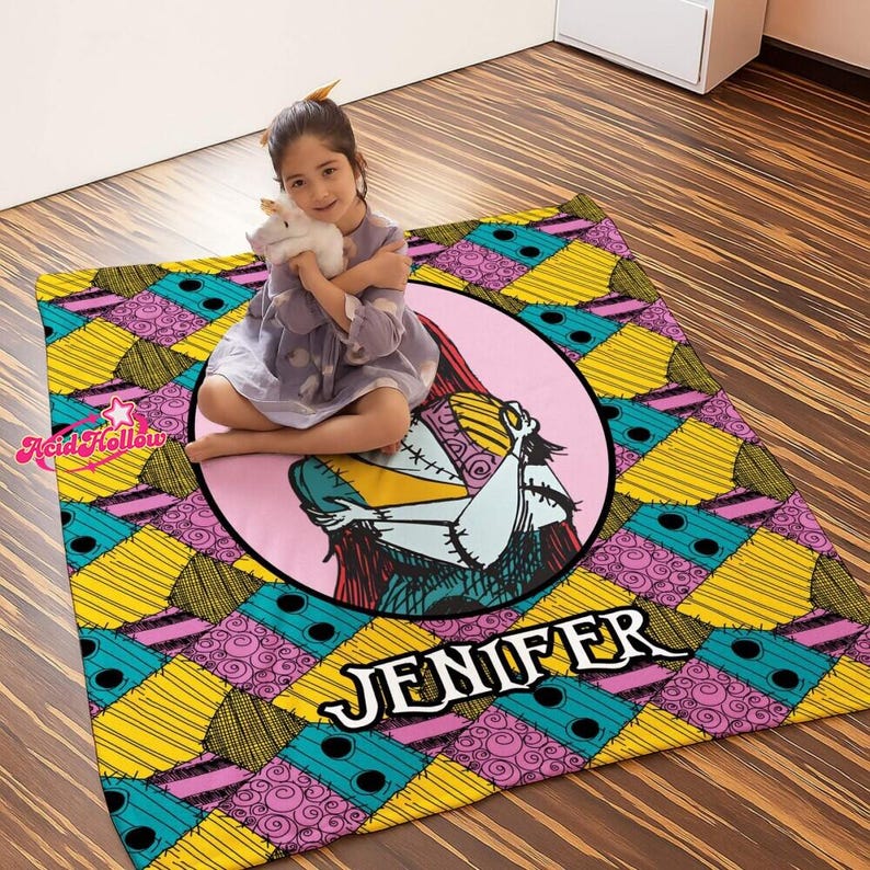 a person holding a colorful, patterned blanket with a design of a character from the movie "Sally's Nightmare".