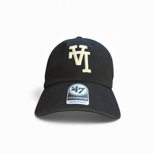 May include: Black adjustable baseball cap with the letters "LA" in cream-colored embroidery on the front. The cap has a curved brim and a small tag with the "47 Clean Up" logo.