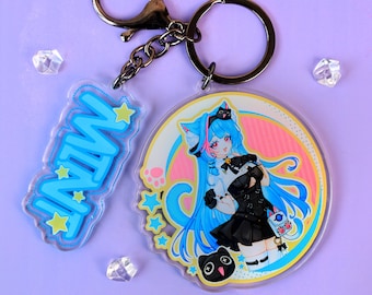 May include: A double-charm keychain featuring a circular acrylic piece with a blue-haired anime character in a black outfit and a smaller rectangular charm with the word MINT in blue letters, both attached to a dark metal split ring and clasp.