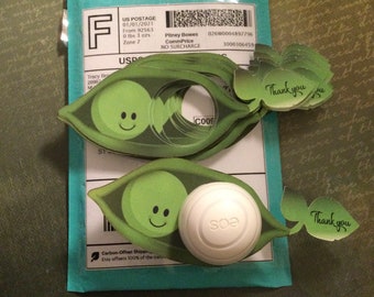 May include: A set of green pea pod shaped stickers with a smiling face on each pea. The stickers have the words "Thank you" printed on them. There is also a white round sticker with the word "soa" printed on it.