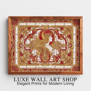 Puede incluir: Arte de pared enmarcado con un diseño Art Nouveau rojo y dorado, que representa el perfil de una mujer. La obra de arte está enmarcada en un marco de madera. El texto en la parte inferior dice "LUXE WALL ART SHOP Elegant Prints for Modern Living."