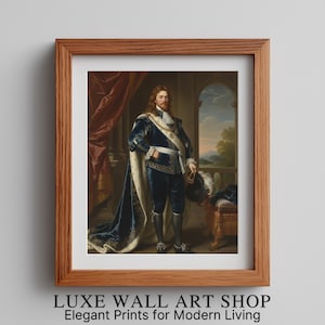 May include: Framed wall art print featuring a portrait of a man in royal attire. The man is wearing a blue velvet suit with a long cape and holding a hat. The frame is made of wood, and the text "LUXE WALL ART SHOP" is at the bottom.