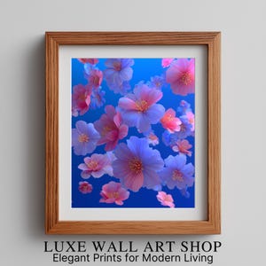 May include: A framed print featuring a vibrant floral design. The artwork showcases numerous flowers in shades of pink and purple against a bright blue background. The frame is made of wood. The text at the bottom reads "LUXE WALL ART SHOP Elegant Prints for Modern Living."