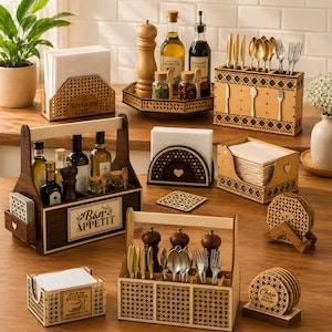 May include: Wooden kitchen organizers and serving trays. Includes napkin holders, utensil caddies, spice racks, and coasters. The items are made of light and dark wood with decorative cut-out patterns. Some items have the words "Kitchen", "Bon Appetit", and "Chase Your Dreams".
